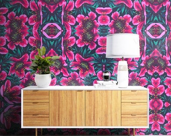 May include: A wooden sideboard with four drawers on each side and two central doors, featuring a white frame and gold legs. On top sits a white potted plant, a white table lamp with a cylindrical base, and a small black decorative object.