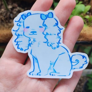 May include: A blue and white sticker of a cartoon dog with a bow on its head. The dog is sitting with its tail curled up.
