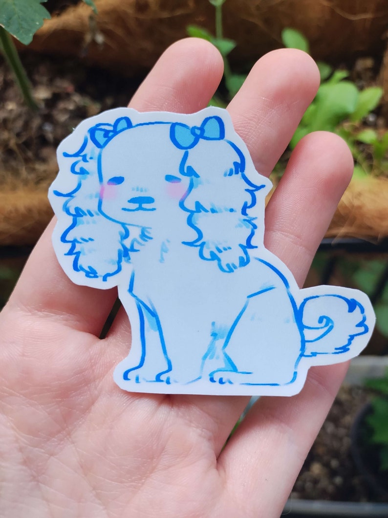 May include: A blue and white sticker of a cartoon dog with a bow on its head. The dog is sitting with its tail curled up.