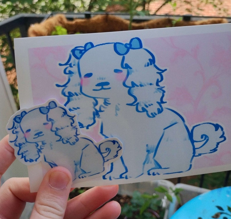 May include: Two white dogs with blue bows on their heads are drawn on a pink background. The larger dog is standing and the smaller dog is sitting. Both dogs have blue eyes and pink cheeks.