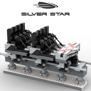 Pu&ograve; includere: Modello di vagone di montagne russe, principalmente grigio e nero, con la scritta "SILVER STAR" sopra. Il vagone ha pi&ugrave; file di sedili ed &egrave; montato su un binario con colonne di supporto. Il design include accenti rossi.