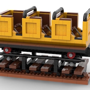 May include: A yellow and brown Lego train car with black railings and red wheels. The car is on a brown track.