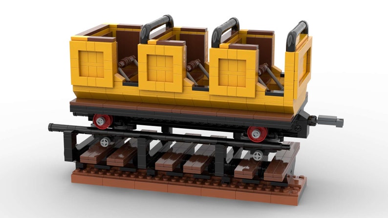 May include: A yellow and brown Lego train car with black railings and red wheels. The car is on a brown track.