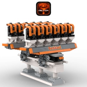 Könnte beinhalten: Ein Lego-Modell der Oblivion-Achterbahn im Vergnügungspark Gardaland. Die Achterbahn ist orange und schwarz mit einer weißen Schiene. Das Modell steht auf einem weißen Sockel mit dem Gardaland-Logo.