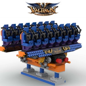 May include: A Lego model of the Valravn roller coaster at Cedar Point amusement park. The model is made of blue, black, orange, and gray Lego bricks. The coaster train is suspended from the track and has multiple seats. The model includes the name "Valravn" and the park's logo.