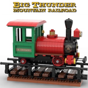 May include: A red and green toy train engine with a black smokestack and a sign that reads "Big Thunder Mountain Railroad". The engine has a green passenger car with the words "J.R. Courageous" on the side.