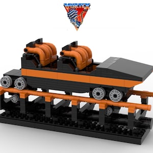May include: A black and orange Lego model of a roller coaster car with the word "VERTEX" in a triangle above it.