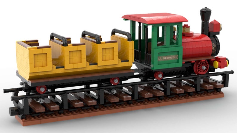 May include: A red and green toy train with a yellow passenger car. The train has a black chimney and wheels and says "Le Courageux" on the side. The train is on a brown track.