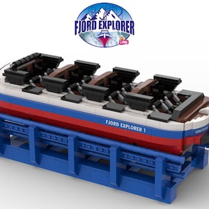 May include: A red, white, and blue boat-shaped ride with black seats and the text "FJORD EXPLORER 1" on the side. The ride is on a blue track.