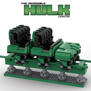 May include: A green Lego model of a roller coaster car with black seats. The car is labelled "The Incredible Hulk Coaster".