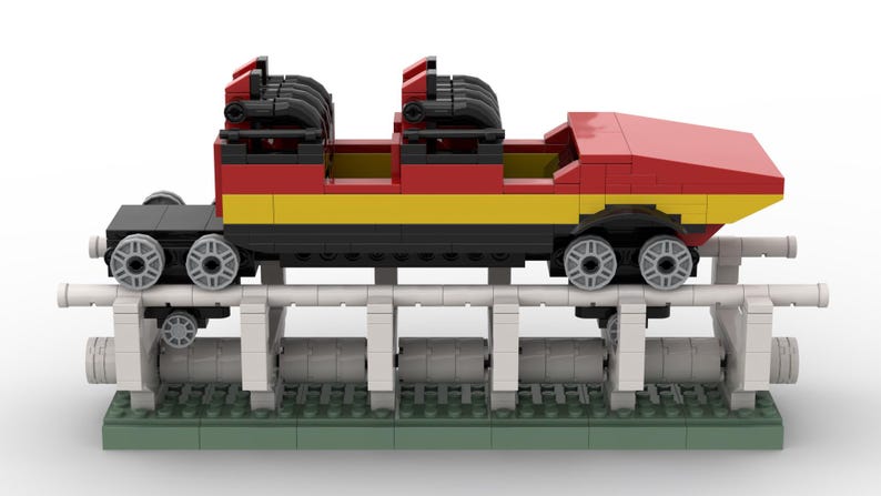 May include: A red, yellow and black Lego roller coaster train with two carriages and a track.