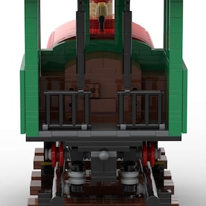May include: A green and red toy train engine with a black chimney and a brown boiler. The engine is on a brown wooden track.