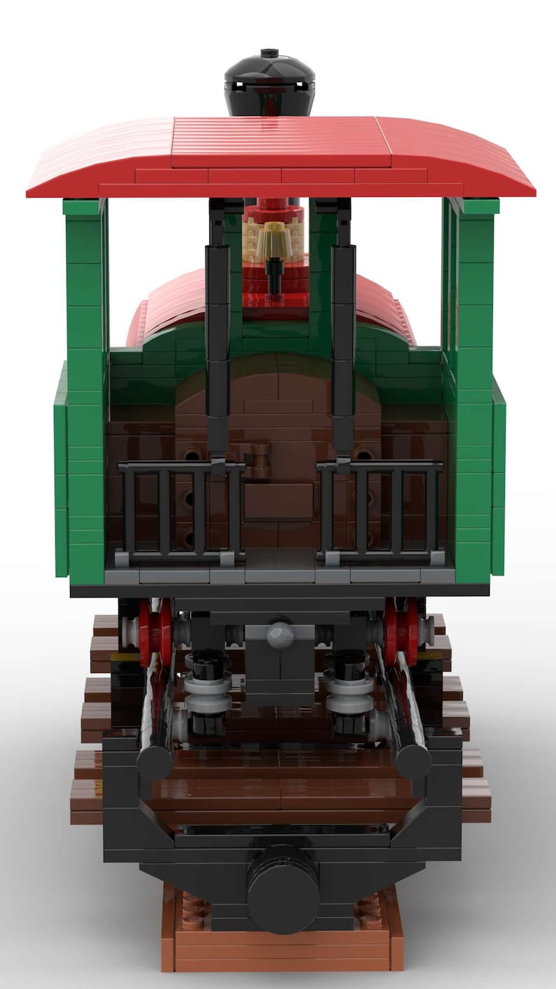 May include: A green and red toy train engine with a black chimney and a brown boiler. The engine is on a brown wooden track.