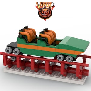 May include: A green and orange Lego roller coaster car with the word "VIPER" in a red and yellow logo above it. The car is on a red track with a white base.