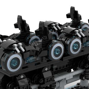 May include: A black Lego model of a futuristic vehicle with four wheels and a detailed design. The vehicle has a sleek, aerodynamic shape and features glowing blue lights on the wheels.