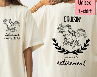 May include: An ivory t-shirt featuring a black graphic of a duck in sunglasses sitting in a beach chair with a drink. The front chest area displays the text Retirement cruise 2026. The back features the same duck graphic with the text Cruisin' my way into retirement.