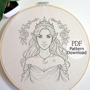 May include: A black and white line drawing of an elven woman wearing a crown, necklace, and gown, surrounded by floral elements, set within a wooden embroidery hoop. The text "PDF Pattern Download" is visible.