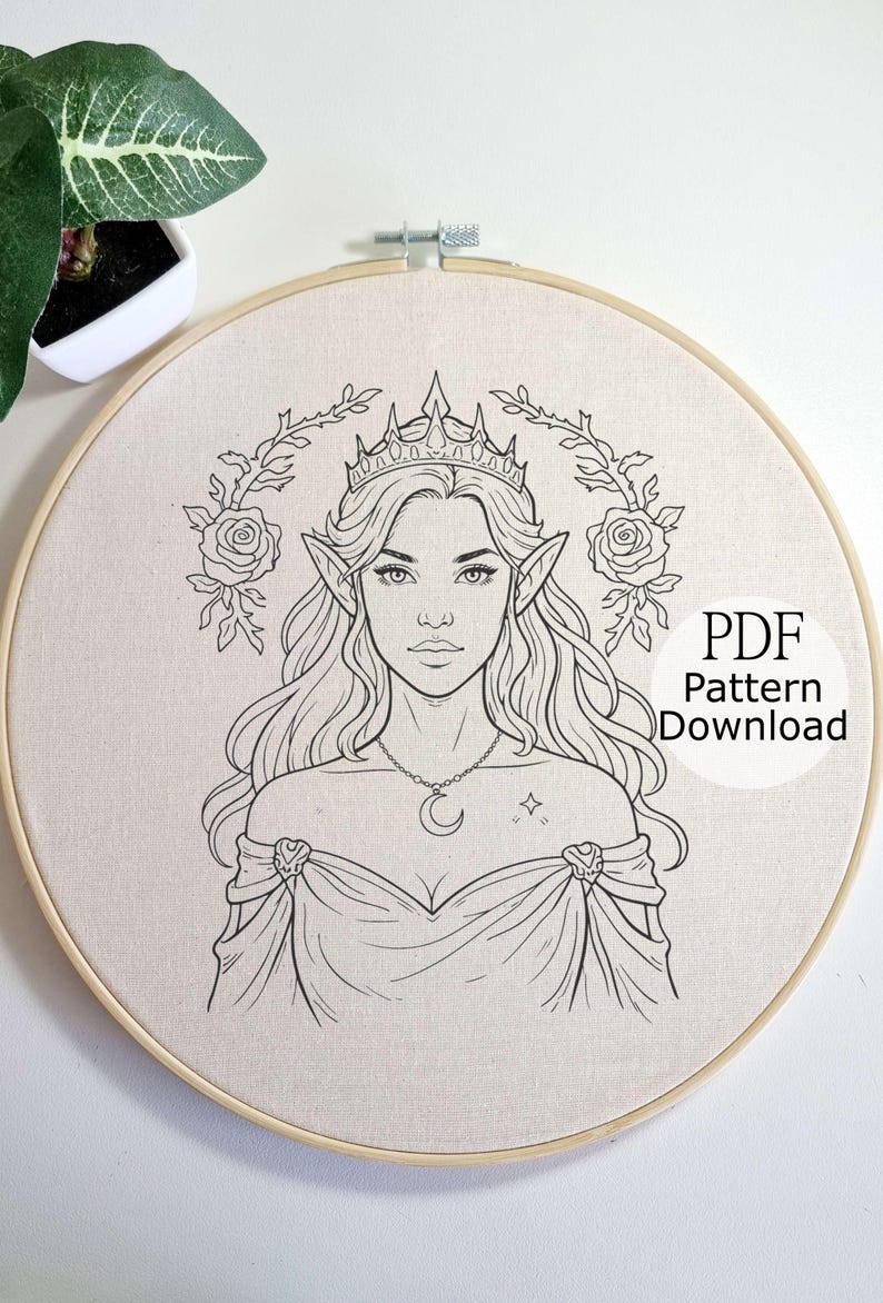 May include: A black and white line drawing of an elven woman wearing a crown, necklace, and gown, surrounded by floral elements, set within a wooden embroidery hoop. The text "PDF Pattern Download" is visible.