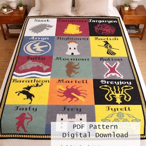 May include: A patterned blanket with house sigils from a fantasy series, including a wolf, lion, and dragon. The design is arranged in squares with house names. The blanket has a black and gold border and is displayed on a bed, with measurements in cm.