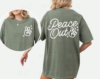 May include: A green t-shirt with the text "Peace Out" and a peace sign graphic printed on the back.