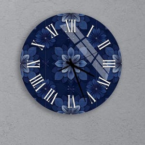 May include: A round wall clock with a dark blue floral design and white Roman numerals. The clock face features a pattern of stylized blue flowers. The clock hands are black.