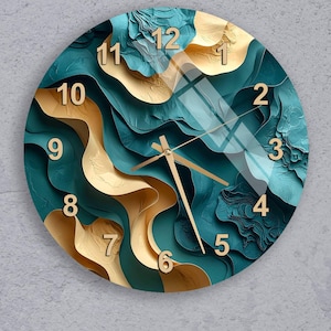 May include: Round wall clock with a teal and gold abstract design. The clock face features a layered, textured pattern with gold numerals and hands. The clock's design incorporates a mix of teal and gold colors, creating a modern aesthetic.