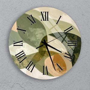 May include: Circular wall clock with an abstract design. The clock face has overlapping shapes in green, brown, and beige. Black Roman numerals mark the hours, and black hands show the time. The clock is mounted on a grey wall.