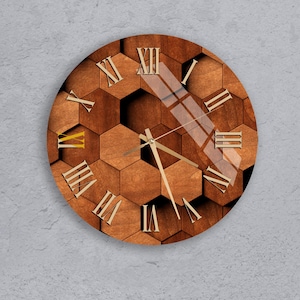 May include: Round wooden wall clock with a geometric honeycomb pattern. The clock face features Roman numerals and gold-colored hands. The clock is made of wood and has a glass cover.