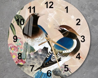 May include: A round clock with a white background and a marble pattern. The clock face features black Roman numerals and gold hands. Two blue and brown birds are perched on a branch with pink flowers.