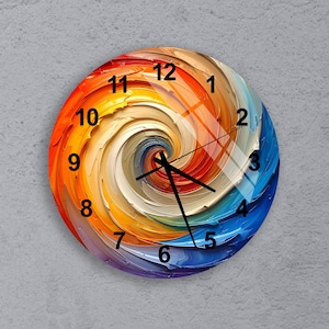 May include: Round wall clock with a colorful abstract design. The clock face features a swirling pattern of orange, yellow, white, blue, and purple hues. Black clock hands and numerals are visible.