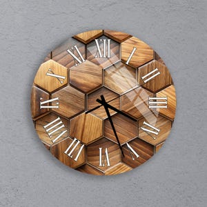 May include: Round wall clock with a wooden honeycomb design. The clock face features Roman numerals in white and black clock hands. The clock is mounted on a gray wall.
