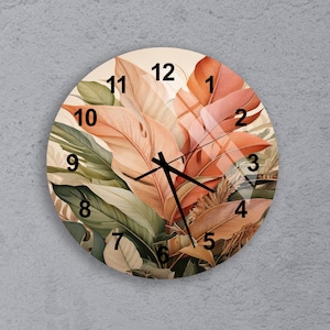 May include: Round wall clock featuring a botanical design with large leaves in shades of orange, green, and beige. The clock face has black hands and black numerals. The clock is a decorative home decor item.