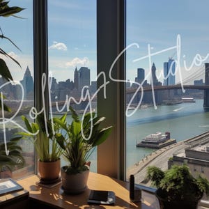 May include: A scenic view through a window, showcasing a cityscape with a bridge and water. The text "Rolling Studio" is written on the window. Potted plants sit on a desk in the foreground, with a clear blue sky in the background.