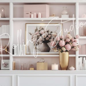 May include: A white bookshelf filled with decorative items. It features books, candles, vases, and a framed floral print. A large gold vase holds pink flowers. The text "Rolling Studio" is written across the image.
