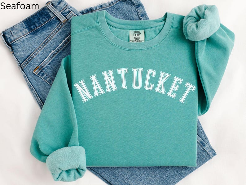May include: Seafoam green sweatshirt with the word "NANTUCKET" in white text on the front.