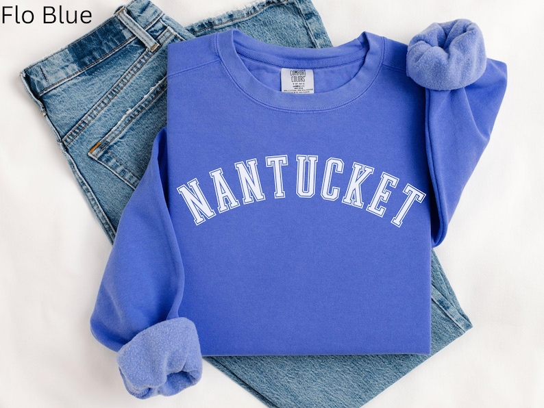 May include: A blue sweatshirt with the word "NANTUCKET" in white lettering across the front.