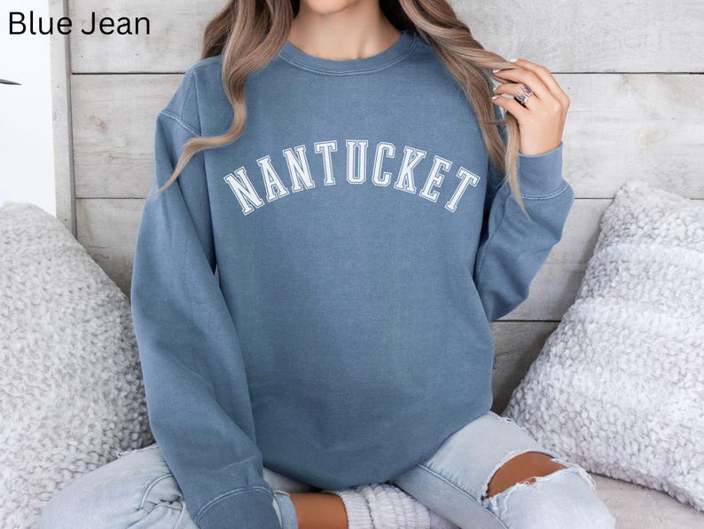 May include: A blue sweatshirt with the word "NANTUCKET" printed in white on the front.