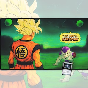 May include: A rectangular mousepad featuring a Dragon Ball Z scene with Goku and Frieza. Goku is in an orange gi with the kanji symbol. Frieza is on the ground with the text "'Tis but a scratch!" A Magic: The Gathering card is in the foreground.