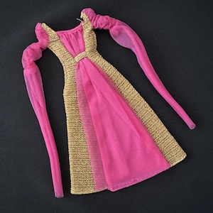 May include: A pink and gold dress with long sleeves and a gathered skirt. The dress is made of a sheer fabric and has a gold trim.