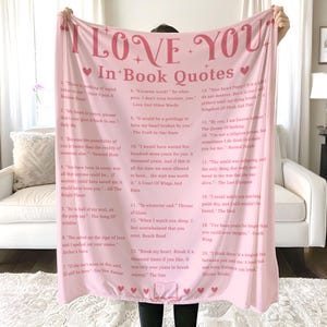 May include: Pink throw blanket with a heart and the words "I Love You" in large pink letters. The blanket features a variety of book quotes in pink text on a white background.