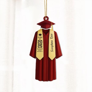 May include: A red graduation cap and gown ornament with a gold tassel and a gold sash that says "Seraphina Rose" and "Class of 2025 Michigan State University".