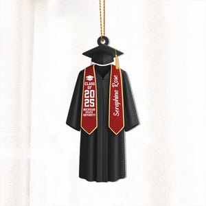 May include: Black graduation cap and gown ornament with a red and gold sash. The sash has the text "Seraphina Rose" and "Class of 2025 Michigan State University".