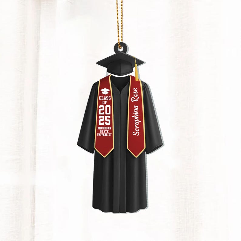 May include: Black graduation cap and gown ornament with a red and gold sash. The sash has the text "Seraphina Rose" and "Class of 2025 Michigan State University".