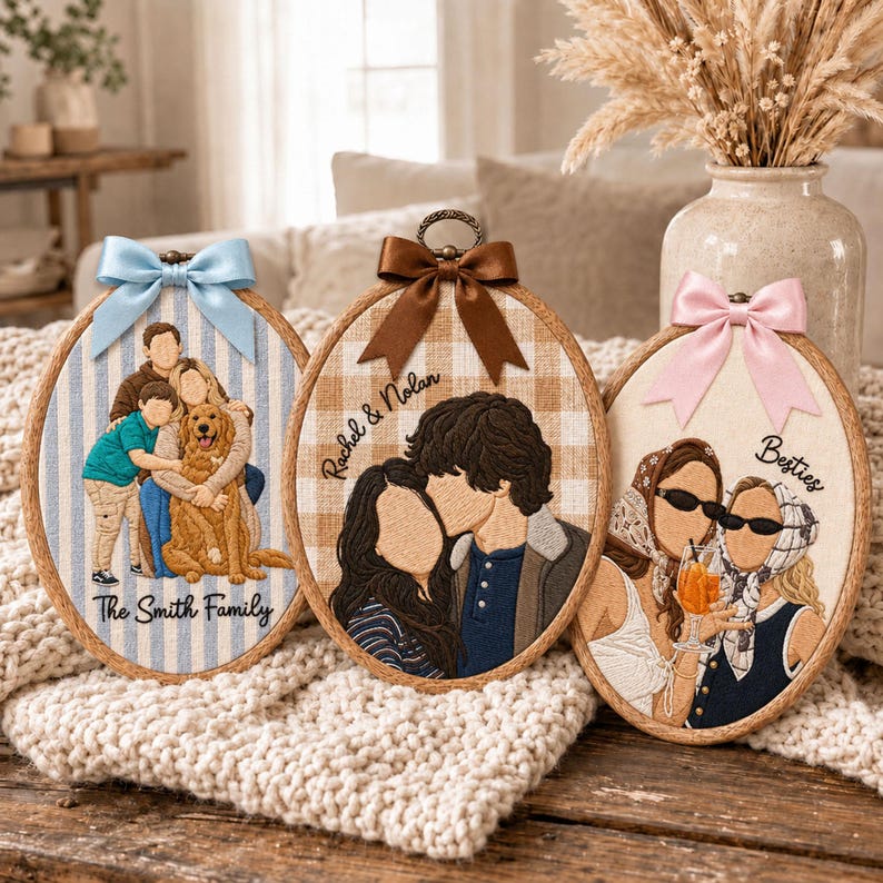 May include: Three oval embroidery hoops featuring custom thread portraits. The left hoop shows a family with a dog on blue stripes with text The Smith Family. The center hoop shows a couple on beige plaid with text Rachel & Nolan. The right hoop shows two people with drinks on cream fabric with text Besties.