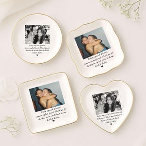 May include: Four white ceramic trinket dishes with gold rims, each featuring a black and white photo and a handwritten message. The dishes are round, square, a unique shape, and heart-shaped, perfect for gifts.