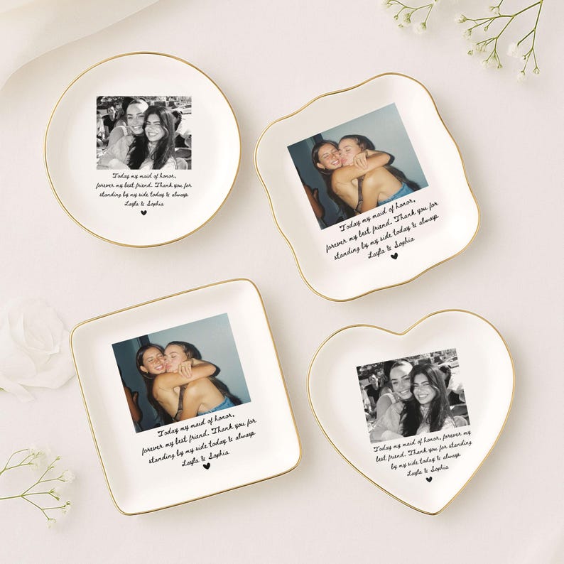 May include: Four white ceramic trinket dishes with gold rims, each featuring a black and white photo and a handwritten message. The dishes are round, square, a unique shape, and heart-shaped, perfect for gifts.