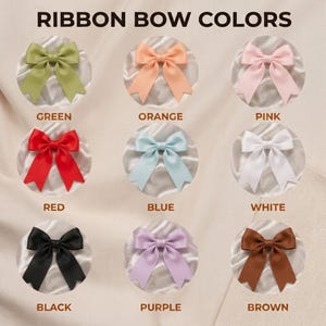 May include: A color chart titled RIBBON BOW COLORS displaying nine satin ribbon bows in green, orange, pink, red, blue, white, black, purple, and brown. Each bow is centered in a circular frame with its corresponding color name printed below it.