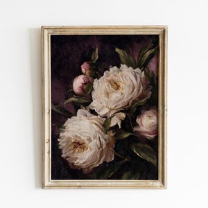 May include: A framed floral print featuring a bouquet of white peonies with yellow centers and pink buds against a dark purple background. The painting is in a gold-toned frame, creating a vintage aesthetic.