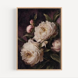 May include: A framed floral print featuring a bouquet of white peonies with green leaves and pink buds against a dark purple background. The artwork is in a wooden frame, showcasing a classic botanical theme.