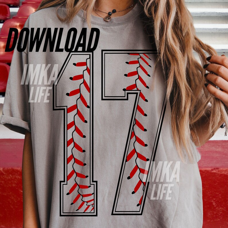 May include: A gray t-shirt with the number 17 in a baseball stitch design. The number is outlined in black with red stitching. The words "DOWNLOAD" and "IMKA LIFE" are printed on the shirt.